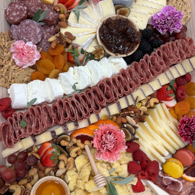 Charcuterie boards near me A colorful assortment of meats, cheeses, fruits, nuts, and honey.